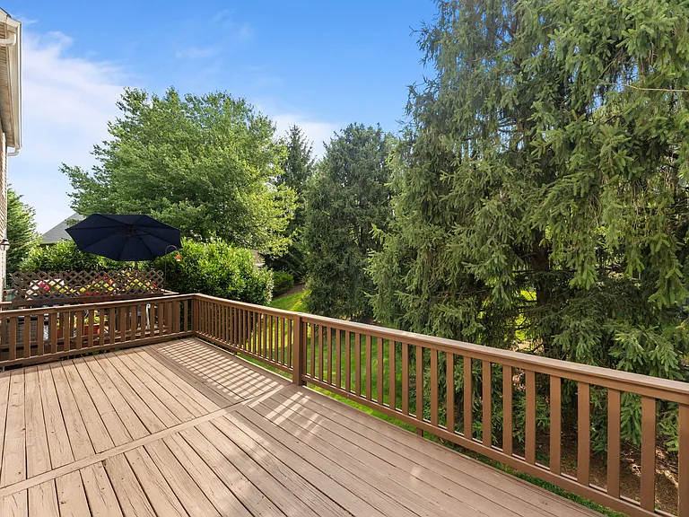 large deck surrounded by mature trees