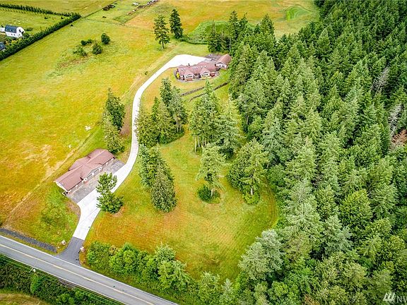 The property has a paved driveway which spans from the entry to the front of the home. 