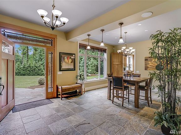 Formal dining  previously had a sideboard/room divider under the pendant lighting. Slate floors underfoot. Room looks south admiring all things 'nature'.