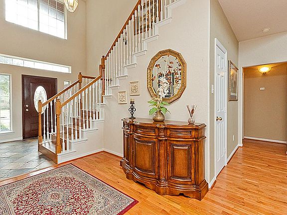 TWO STORY ENTRY WITH SLATE AND WOOD FLOORING ~