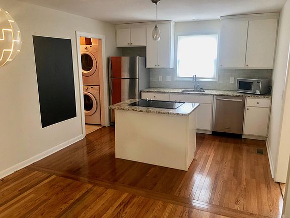 Kitchen viewed from open concept dining area, all stainless appliances included.