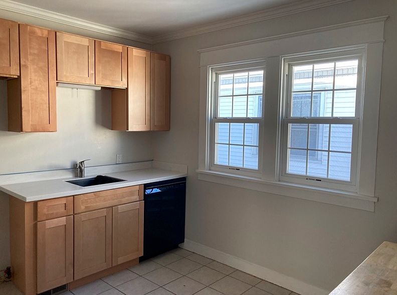 Updated kitchen with new cabinets, work-station sink, and appliances.