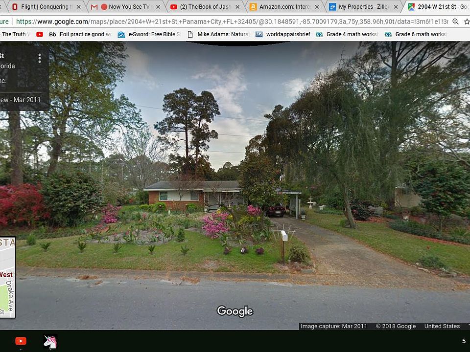 View of the front yard with many blooming flowers.