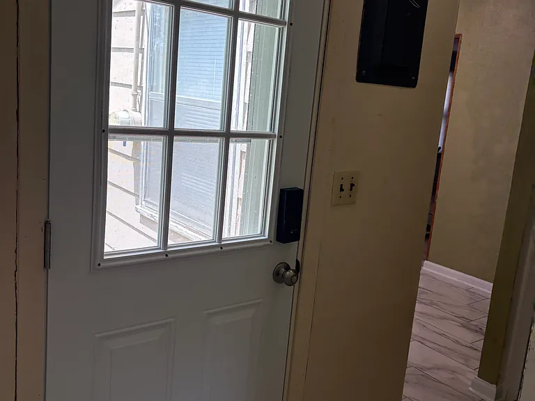 Side door from utility room to outside sidewalk