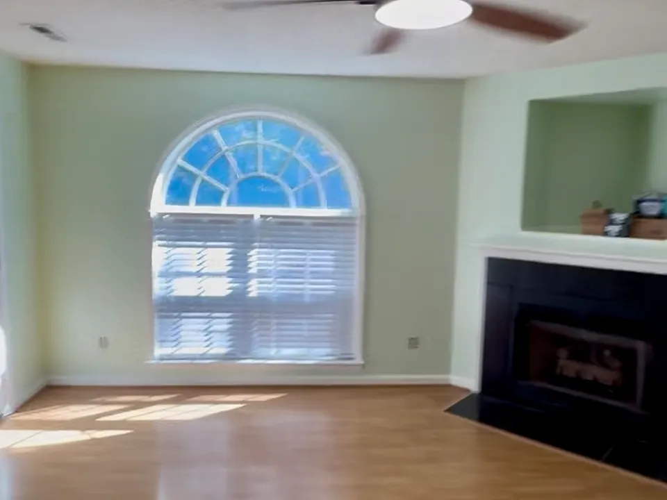 living room with fireplace and picture window