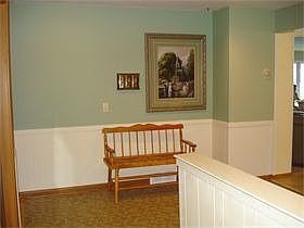 Large, open foyer with stairs leading to the spacious lower level.