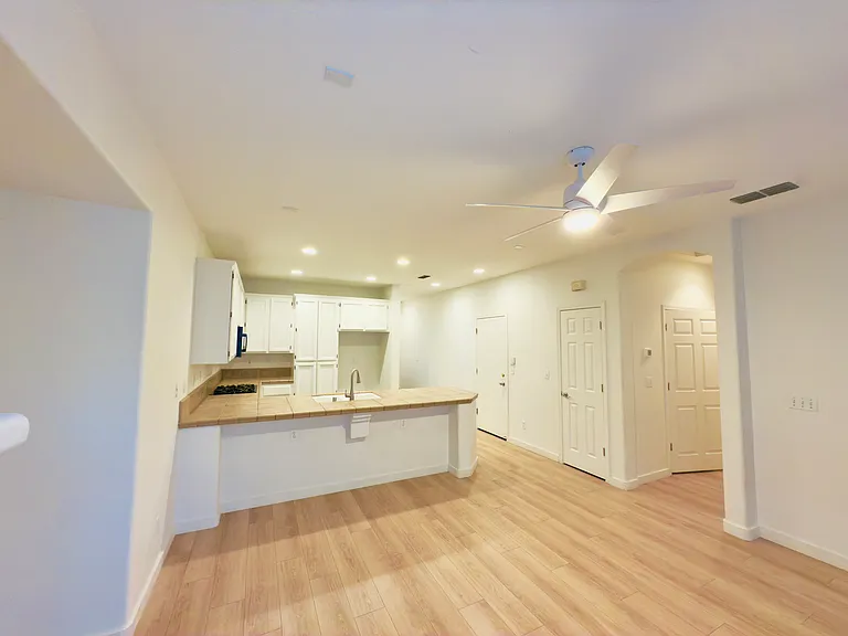 The kitchen boasts a sleek U-shaped modern design, high ceilings, and the perfect layout for cooking and entertaining!