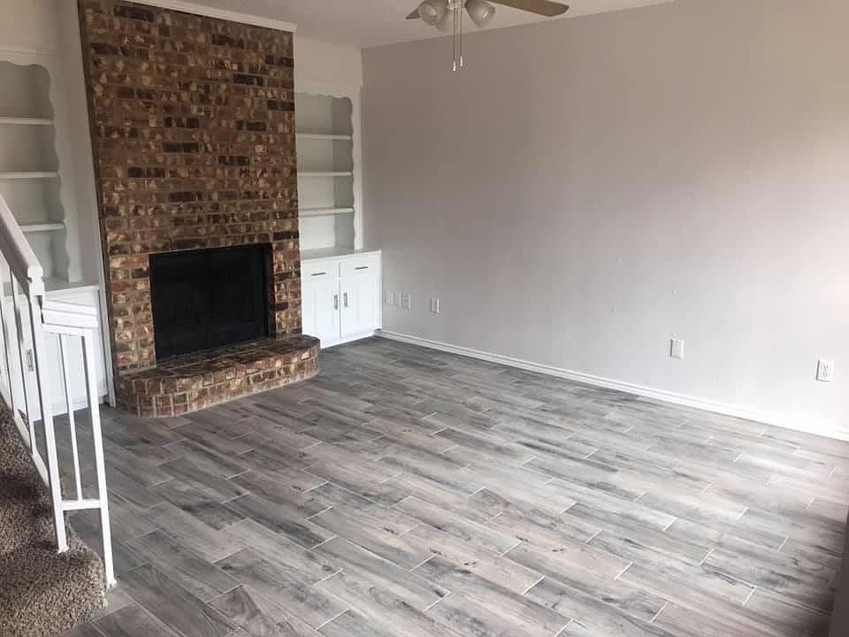 Living Room with built in bookcases & Storage. Tile flooring
