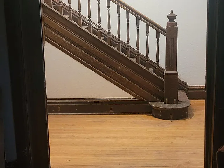 View of stair case from 4th bedroom with tiger wood double doors opened up