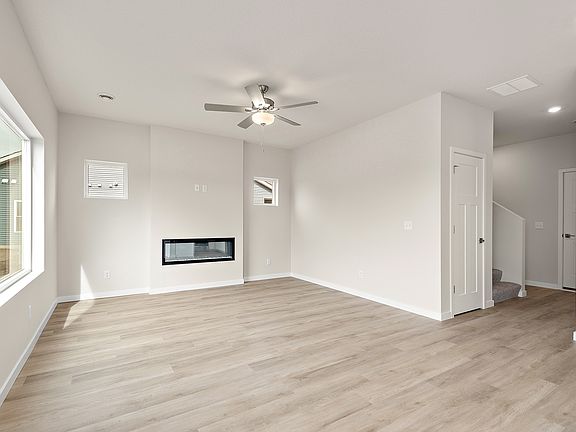 The family room is spacious with a ceiling fan.