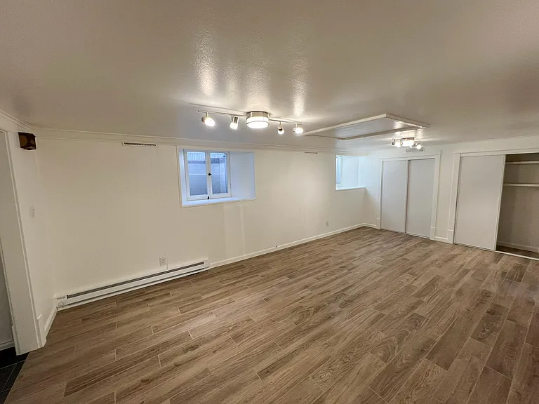 Living room with new floors, new lights, freshly painted, classically detailed trim