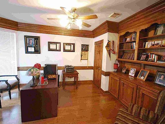 Private study with extensive crown molding and built-in bookcase.