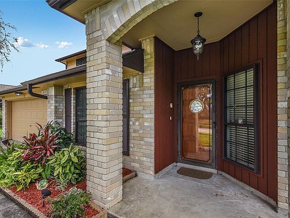 Stunning entryway with glass storm door protecting the solid wood door.