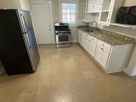 Kitchen with gas range and fridge