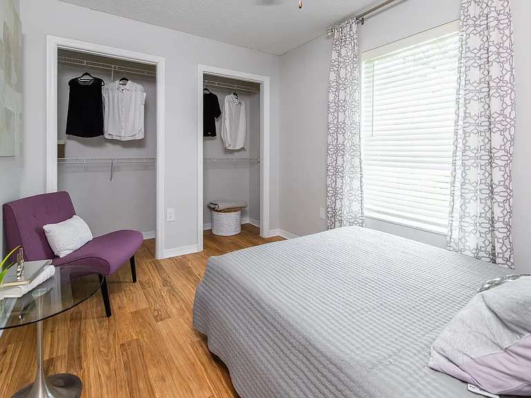 This cozy second bedroom is perfect for guests, a home office, or a stylish retreatcomplete with dual closets and modern wood-style flooring.