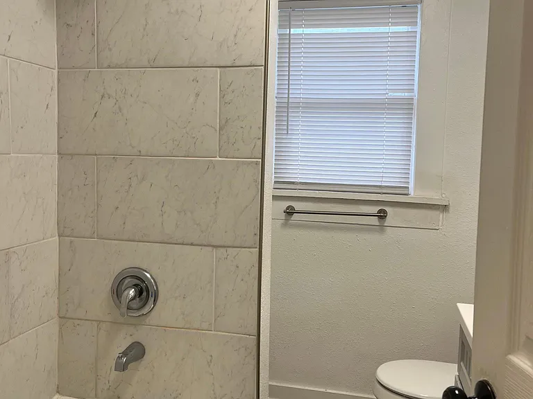 Hall bath with tiled full bathtub