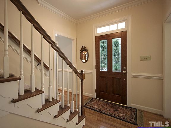 Gracious foyer with hardwood floor and chair rail.  Note the architectural detailing on the staircase.