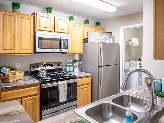 Discover the heart of home with signature kitchen elegance of modern upgrades - featuring wood-style flooring, granite-style countertops, and stainless steel appliances - creates a space that's as inviting as it is practical.