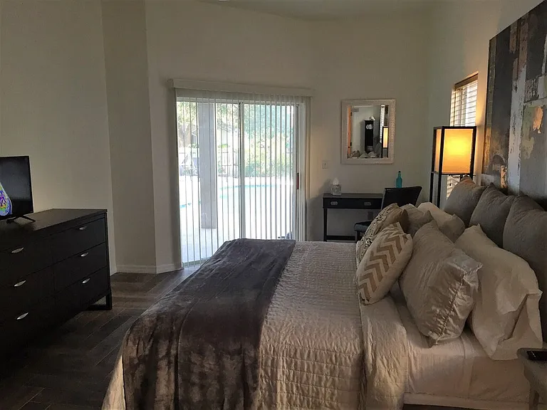 Master bedroom is light and bright with office or flex space and sliders out to pool area.