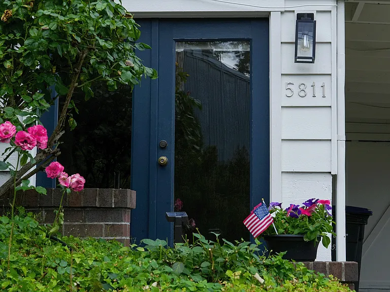 Lower level of duplex, main door next to carport