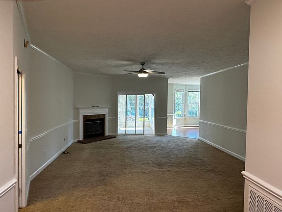 Living room as enter home from Foyer. Note enclosed porch beyond sliding doors