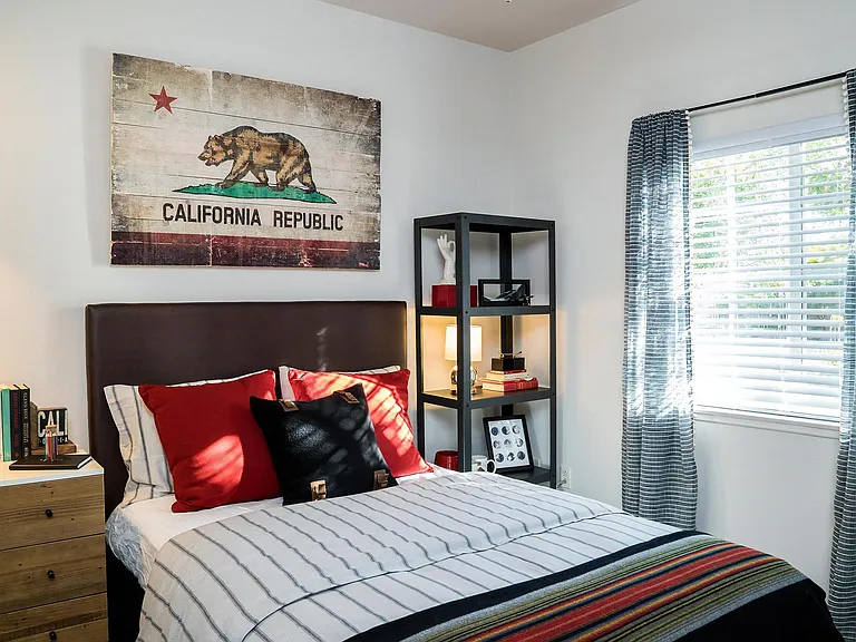 Guest Bedroom with Framed Wall Decor and Natural Lighting