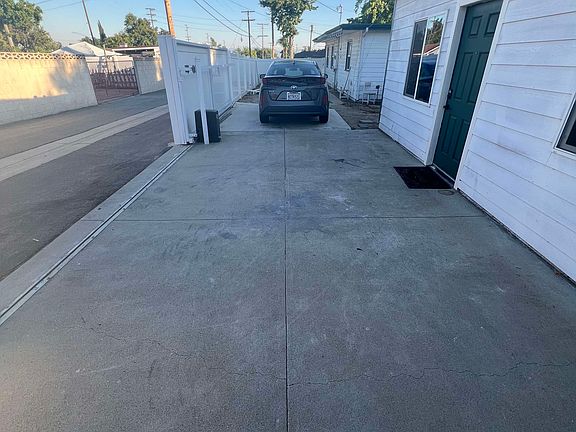 Large parking lot that can accommodate up to two small cars. A newer metal shed has just been installed by current tenants. Shed will be staying.