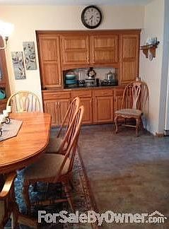 Kitchen into dining room
						:
						Quartz countertops, black electric cooktop in island, breakfast counter & nook