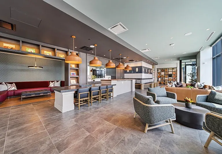 Lofted comfort _ a resident lounge that blends industrial edge with homey warmth and citylight vibes.