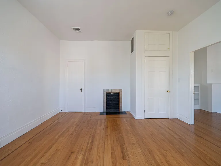 Bedroom 1 with 2 closets (one cedar lined) and upper storage and non-useable fireplace.