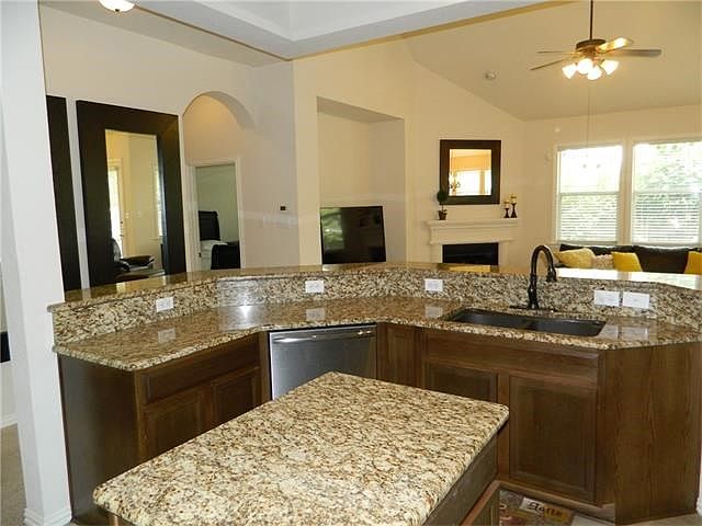 Kitchen open to the family room.  Lots of cabinets and granite countertops.