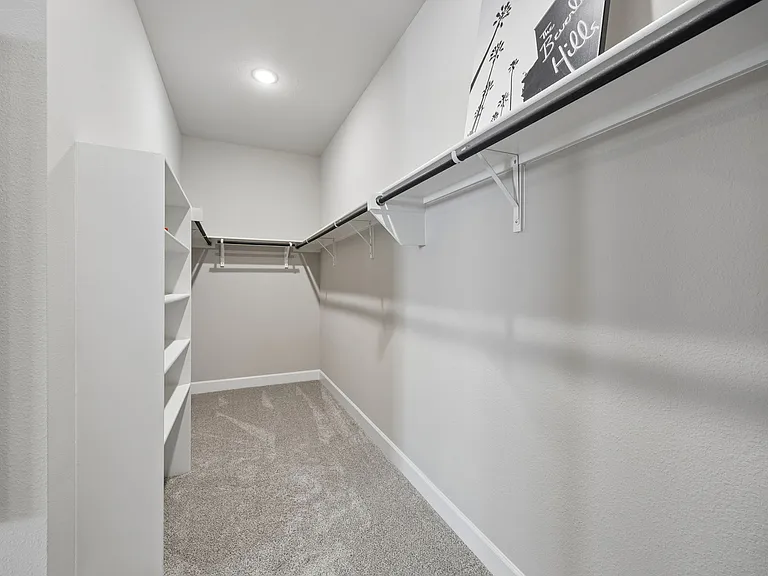 XL primary walk-in closet with shelfing throughout