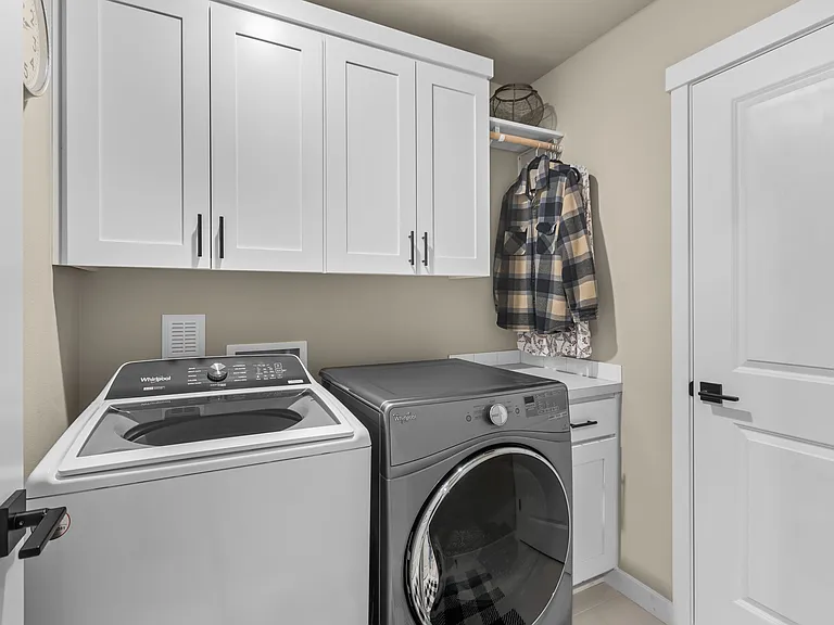 Convenient Upstairs Laundry and Large 74" x 60" Storage Closet with shelving.