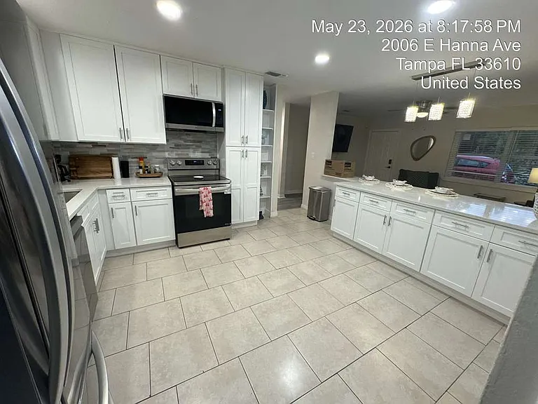 Bright, open kitchen with white cabinetry and plenty of counter space.