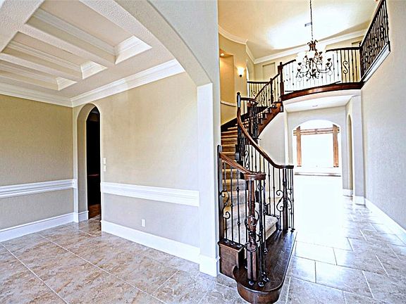 Stunning Soaring Ceilings with Crown Molding and Custom Baseboards.