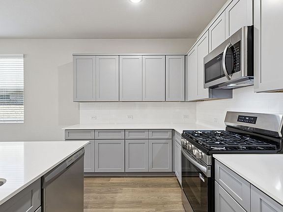 Kitchen in the Haylee home plan by Trophy Signature Homes - REPRESENTATIVE PHOTO