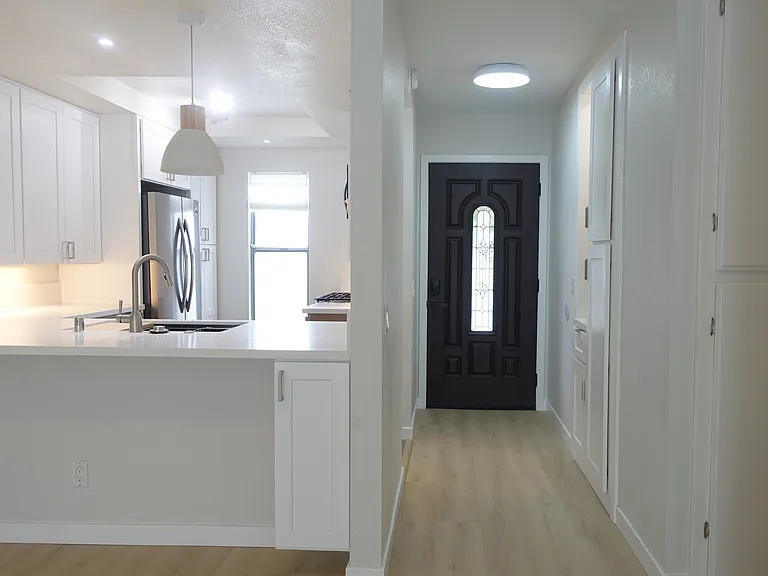 Front Hall: Built-in cabinets with closet rod and interior light. Oak flooring and white/oak ceiling light