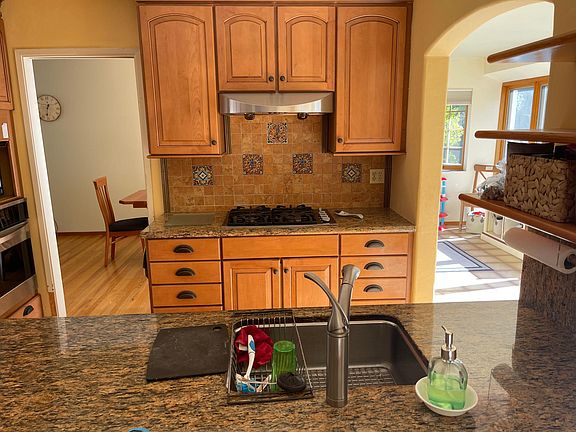 Kitchen, island in foreground, doorway to dining room on left, solarium on the right.