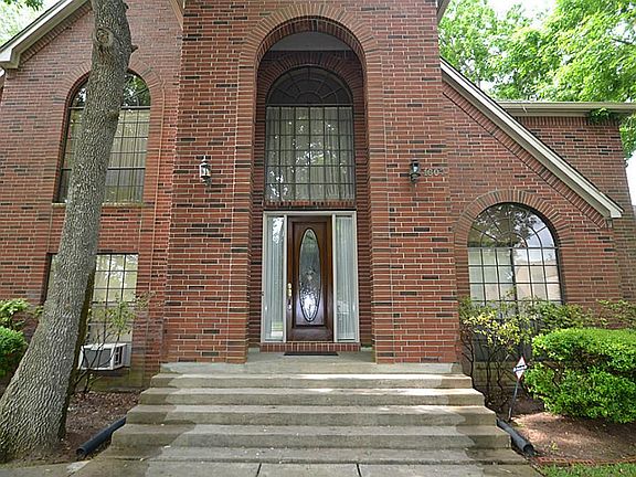 High arched front doorway inviting you inside.