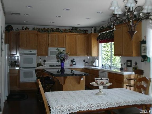 LARGE OPEN KITCHEN WITH LARGE PANTRY, DOUBLE OVENS, ISLAND AND V