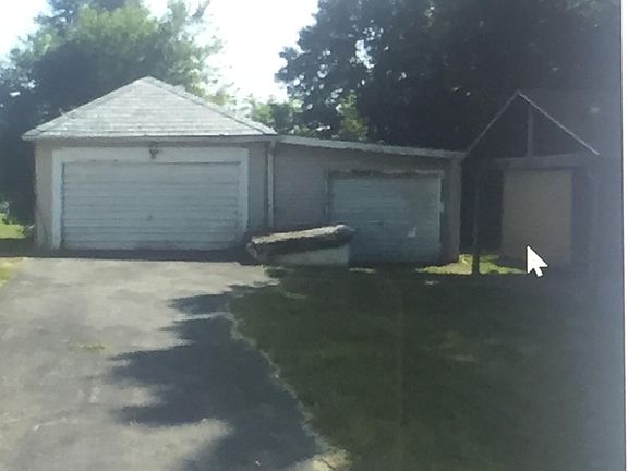 driveway and garages with shed