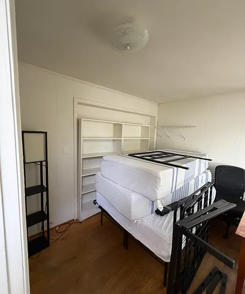 On the main floor are two bedrooms, one in front and one at the rear.
Double bed and mattresses in the rear bedroom can remain.