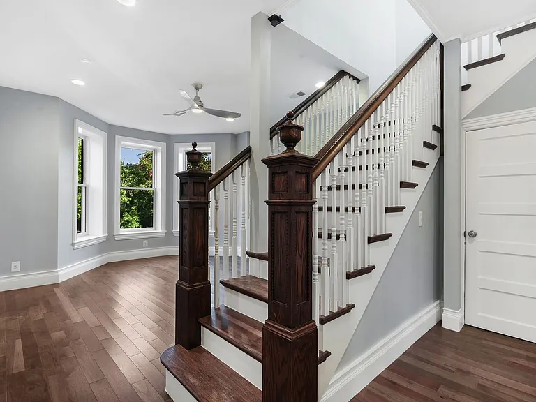 basement door beside staircase; living room in background