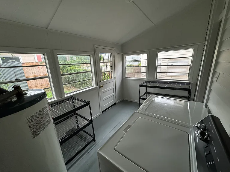Utility Room with full-size washer and dryer, and storage
