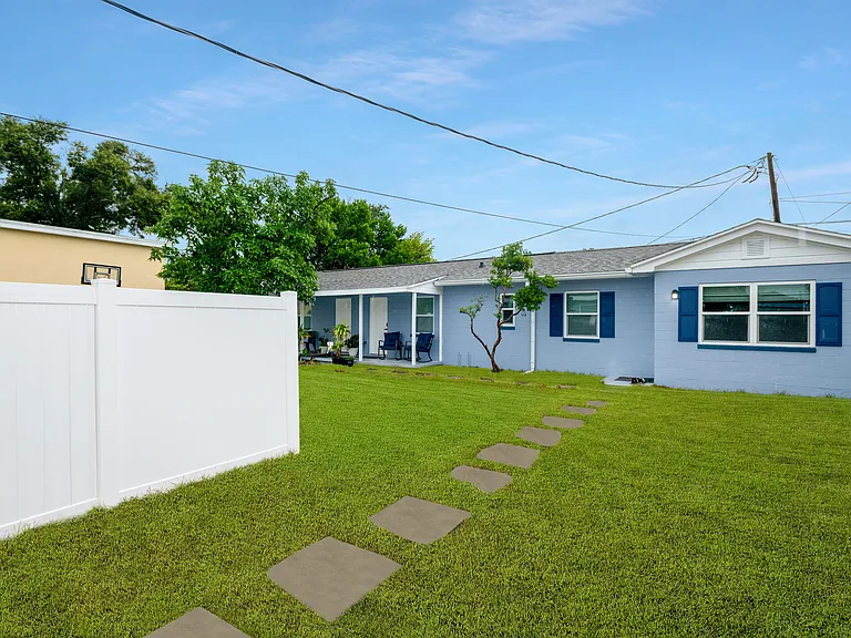 Fenced in Backyard with paved walkway