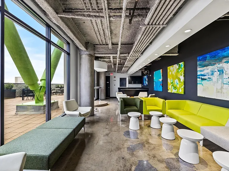 Expansive floor-to-ceiling windows overlooking an outdoor terrace