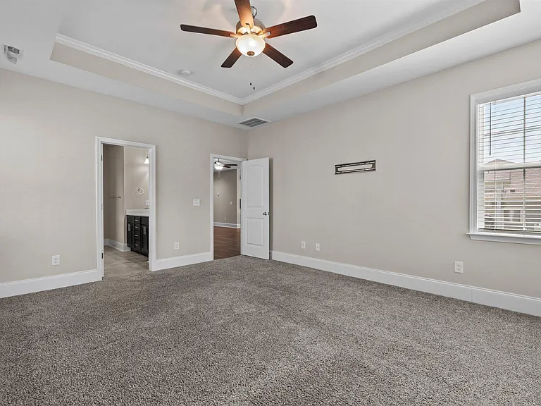 Master bedroom leading to master bathroom and to living room (RH door).