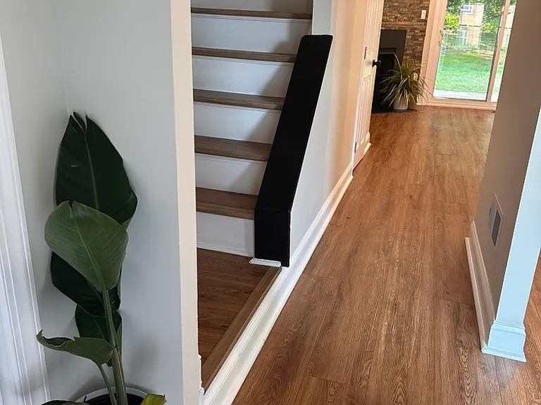 Elegant wood staircase connecting living and bedroom levels_enhancing the home's character and creating a seamless, stylish flow.
