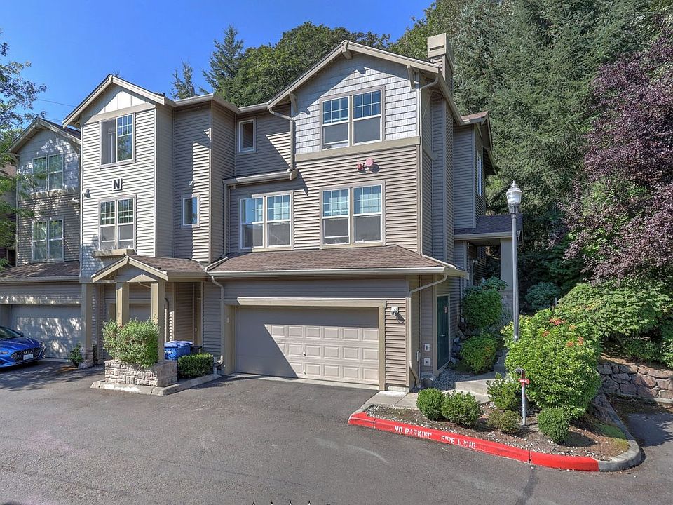 Don't miss this stunning Townhome in River Ridge! This End-Unit has all the comforts of a single family home. High end upgrades throughout this spacious 1,871 Sq ft home. Real hardwood flooring in the kitchen and dining room. New stainless steel appliances(2020) in the kitchen and granite countertops make for chefs delight. Peaceful, back deck with concrete patio for bbqs. Spacious living room with many windows bring in an abundance of natural light! Lovely gas fireplace and surrounding built-ins makes this area the center of the home. A 1/2 bath completes the main level. Upstairs contains master suite plus 2 more bedrooms and another full bath. Lower level has enormous living space or 4th bedroom and HUGE Storage area. Oversized 2 car.>