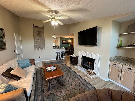 Living Room with fireplace. New flooring throughout! New granite on wetbar.